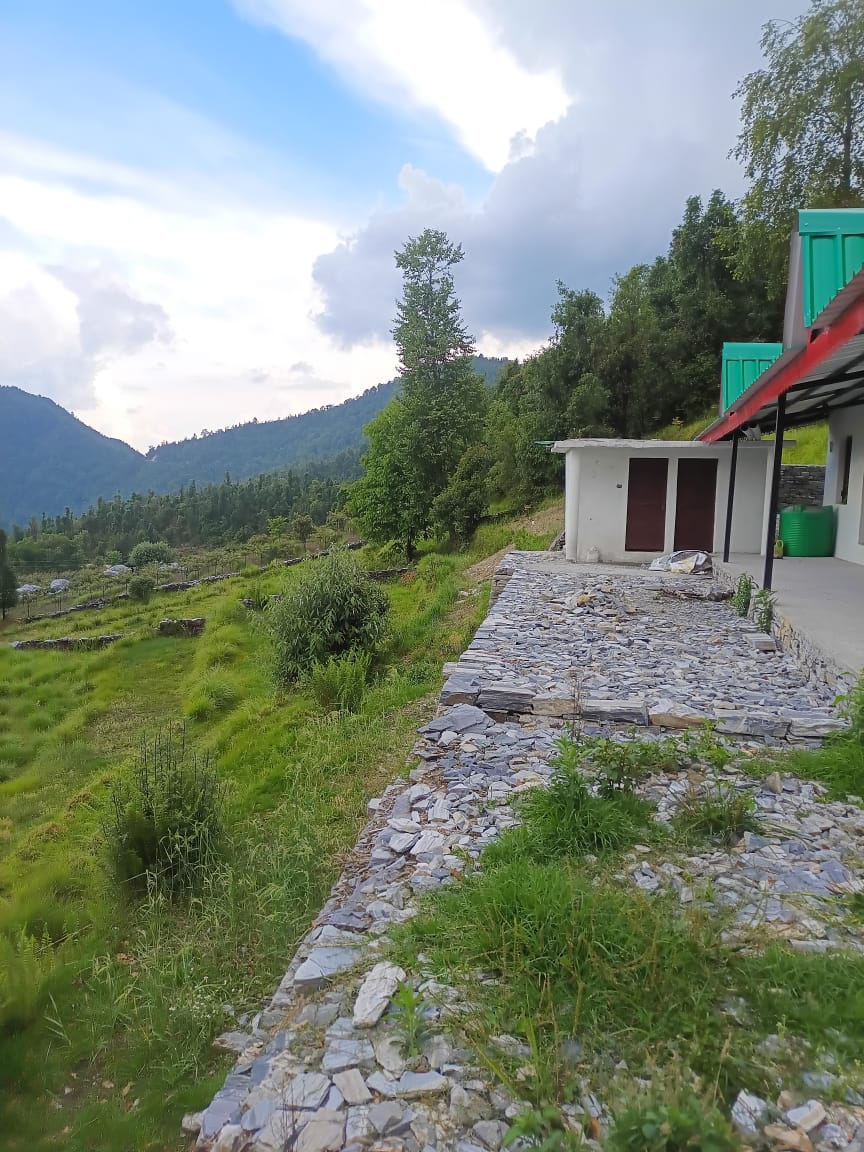 Stone path and cottages on the ridge at Liti360